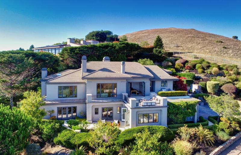 White home on grass hill